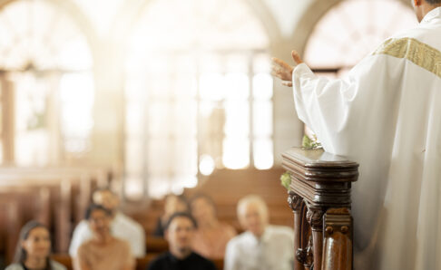 Congregation, religion and faith with priest, in church and preaching sermon, speaking and spiritual. Leadership, talking and connect with people, believers and in chapel for forgiveness or guidance.